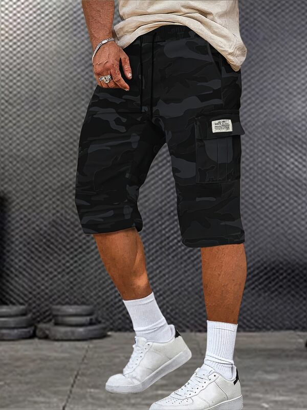 A Pair of Mid to Long Casual Pants with a Camouflage Pattern, Featuring Large Pockets And Patched Pockets with Tags. The Waist Has a Drawstring Design.