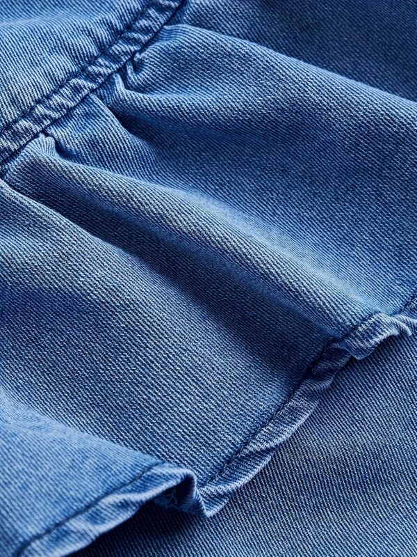 Retro vibe in full swing! Blue denim skirt with irregular ruffle hem and drawstring waist for a relaxed, casual look. Perfect for Casual Attire - Image 3